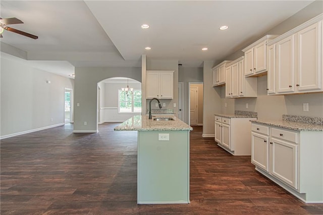 kitchen with recessed lighting, a ceiling fan, arched walkways, and a sink