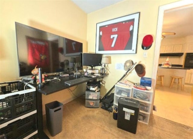 carpeted office space featuring ceiling fan