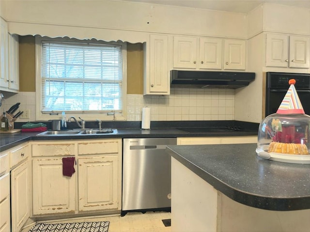 kitchen featuring tasteful backsplash, under cabinet range hood, white cabinets, black appliances, and a sink