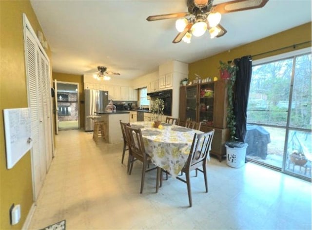 dining space with a ceiling fan and light floors