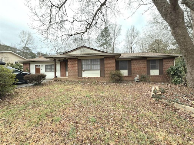 ranch-style house featuring brick siding