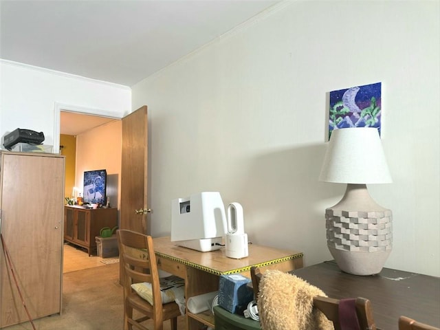 dining room with crown molding and light carpet