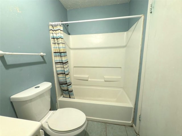 full bath with tile patterned flooring, toilet, shower / bath combo with shower curtain, and a textured ceiling