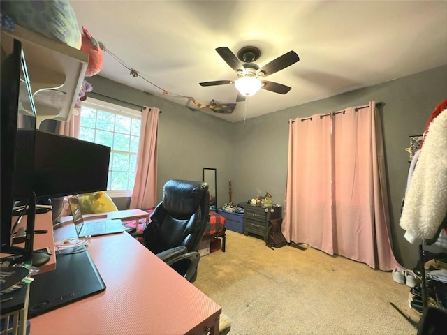 carpeted office space featuring a ceiling fan