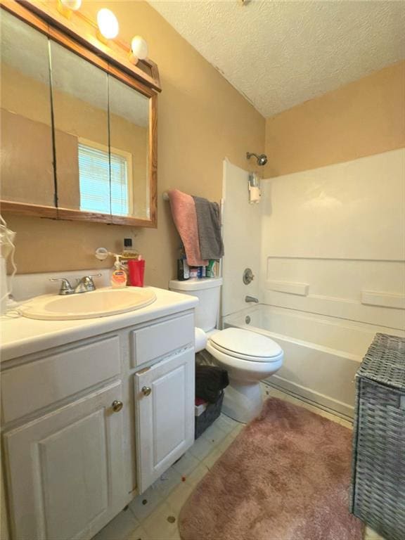 bathroom featuring a textured ceiling, bathtub / shower combination, vanity, and toilet