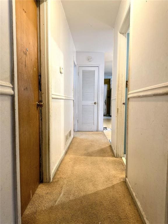 hallway with visible vents and carpet floors