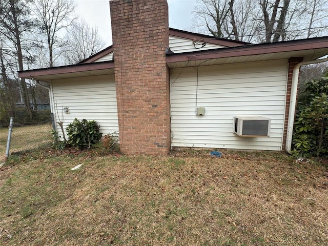 view of property exterior with a lawn and a chimney