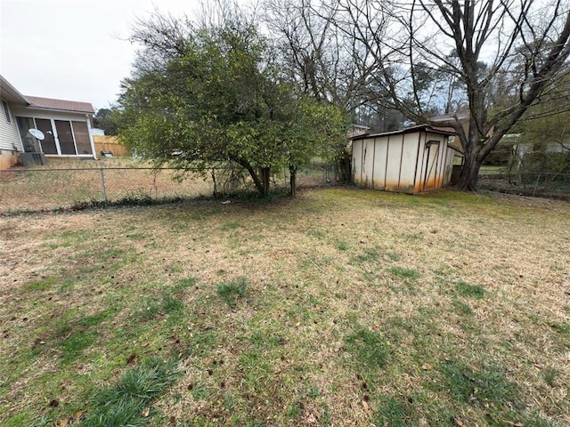 view of yard featuring a storage shed, an outbuilding, and a fenced backyard