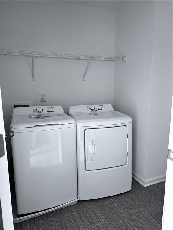 clothes washing area with separate washer and dryer