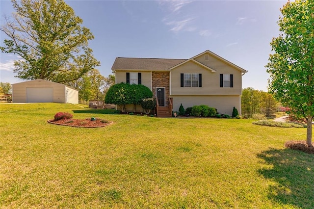 split foyer home featuring a garage, an outdoor structure, and a front lawn