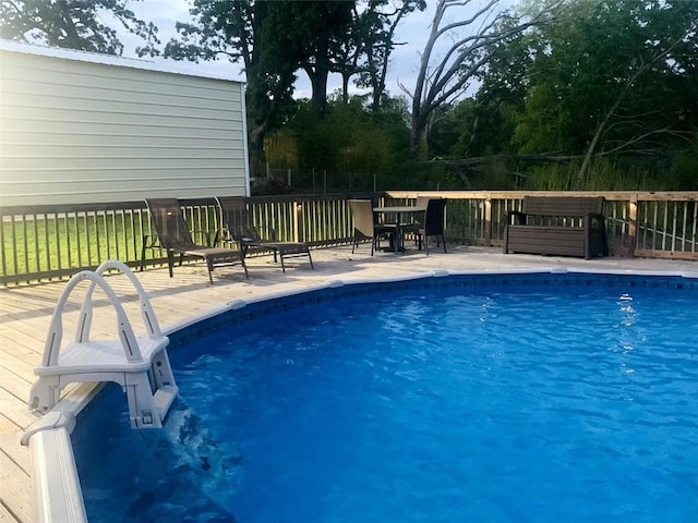 outdoor pool with a wooden deck