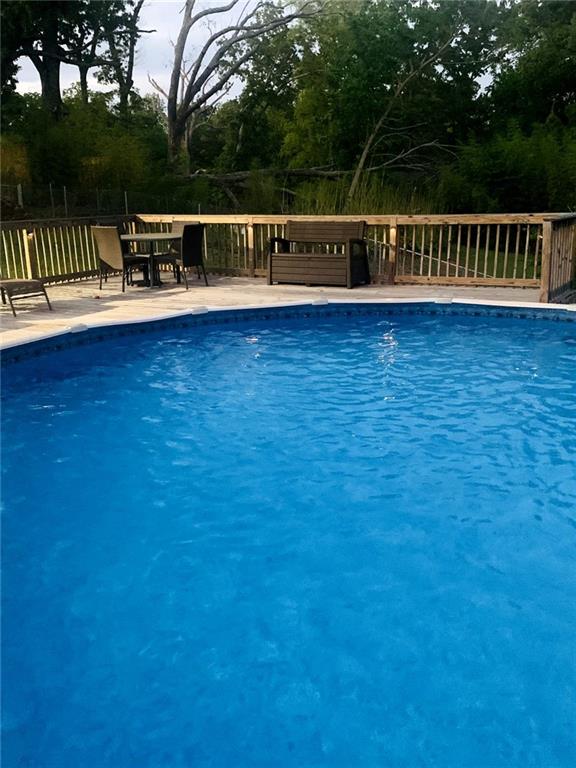 outdoor pool featuring fence