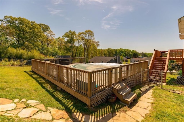 wooden deck featuring a lawn, fence, and stairway