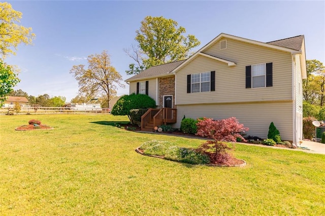 view of front of house with an attached garage, driveway, and a front yard