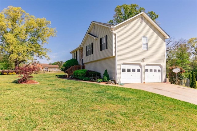 view of side of property with a lawn, driveway, and a garage