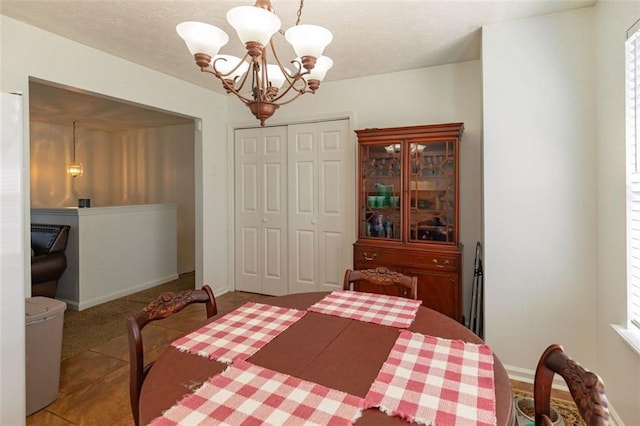 bedroom featuring baseboards, a closet, and a chandelier