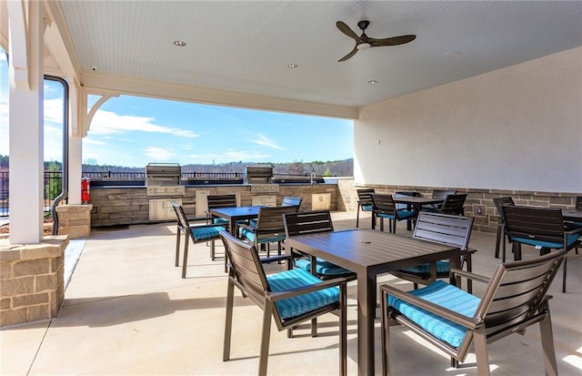 view of patio with an outdoor kitchen and ceiling fan