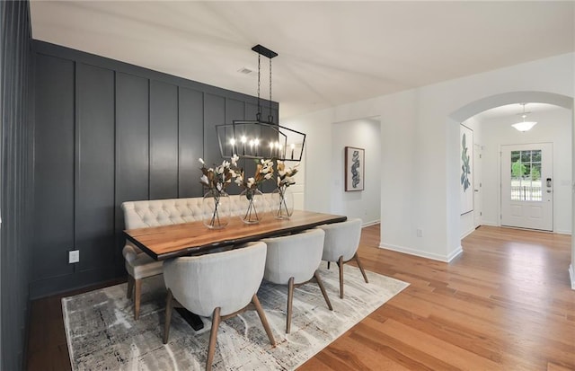 dining area with a chandelier and light hardwood / wood-style floors