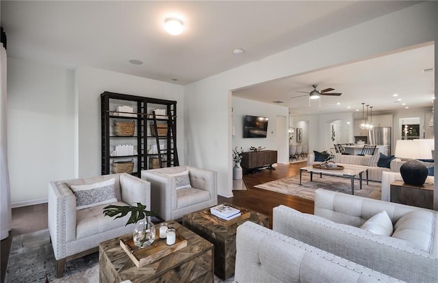 living room featuring dark hardwood / wood-style floors and ceiling fan