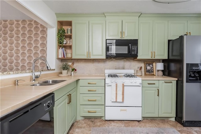 kitchen featuring green cabinets, black appliances, a sink, and light countertops