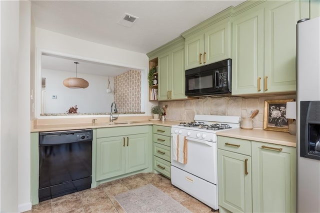 kitchen with a sink, black appliances, visible vents, and green cabinetry