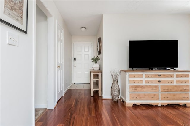 interior space featuring dark wood-type flooring and baseboards