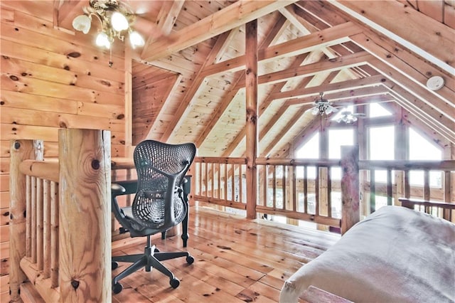 bedroom with multiple windows, wood walls, hardwood / wood-style floors, and lofted ceiling with beams