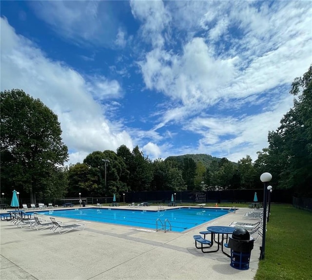 view of swimming pool with a patio area