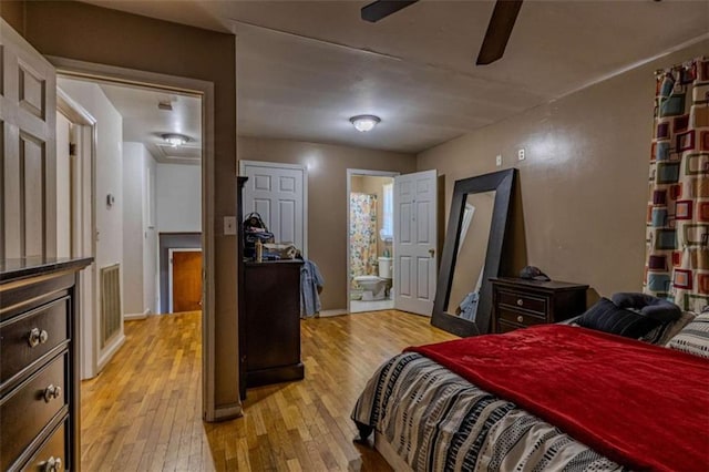 bedroom with ensuite bath and light wood finished floors