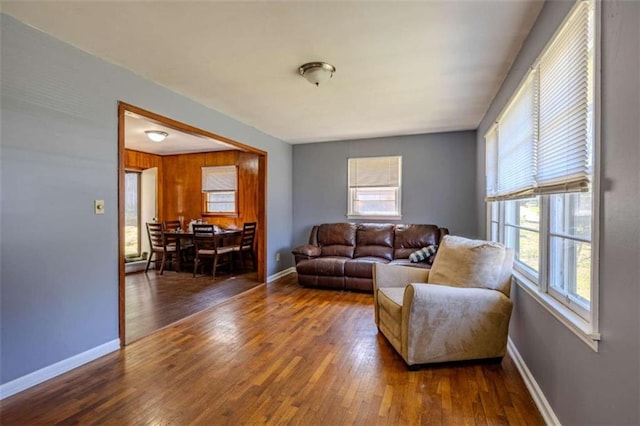 living area featuring hardwood / wood-style flooring and baseboards