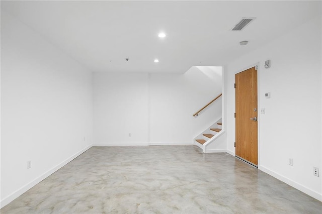 unfurnished room with visible vents, recessed lighting, stairway, baseboards, and concrete flooring