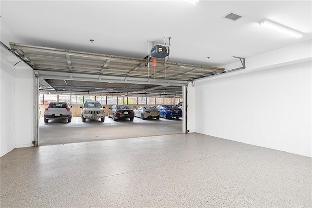 parking deck featuring a garage door opener and visible vents