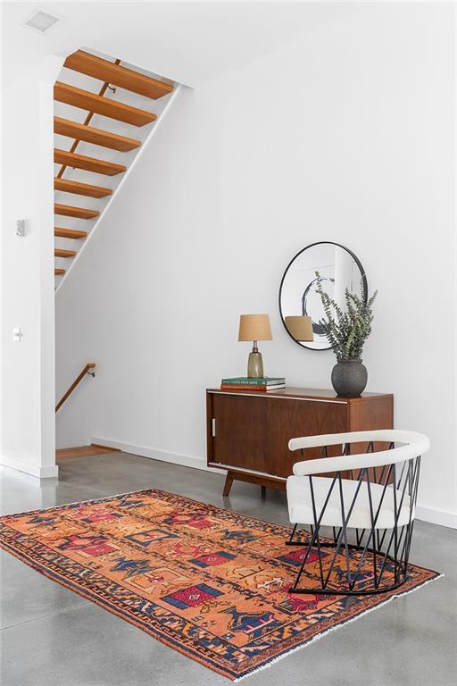 interior space with visible vents, baseboards, and concrete flooring