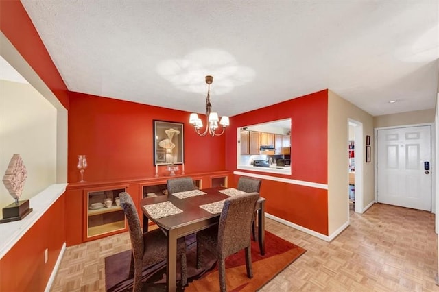 dining space with a chandelier and baseboards