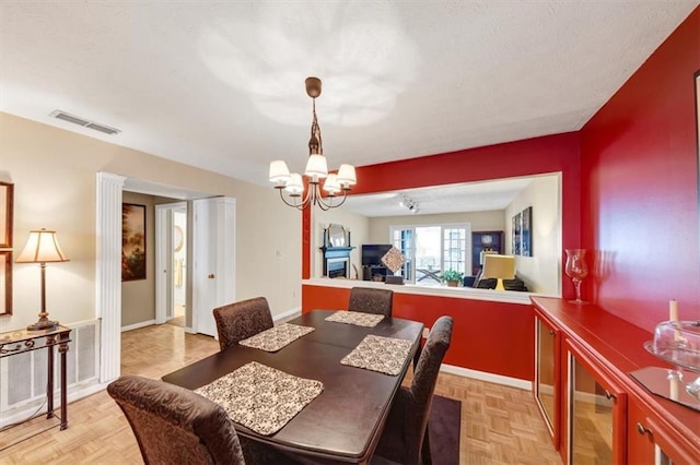 dining area with a chandelier, beverage cooler, and baseboards