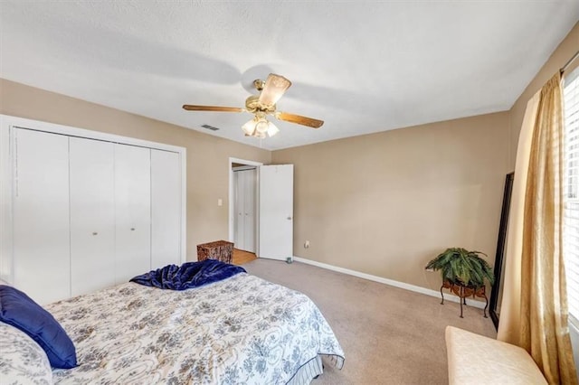 bedroom with carpet, baseboards, a closet, and a ceiling fan