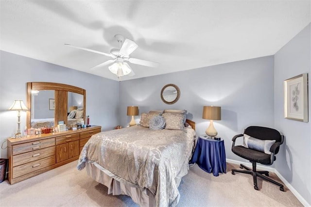 bedroom with light carpet, baseboards, and a ceiling fan