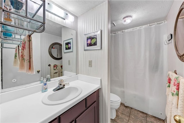 full bath with toilet, shower / tub combo with curtain, vanity, a textured ceiling, and tile patterned flooring