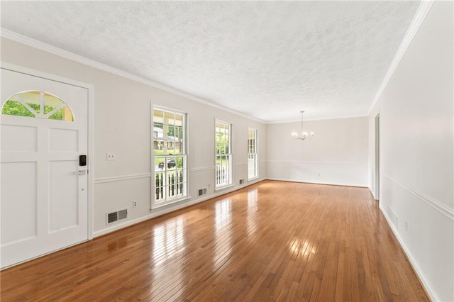 4135 Shoshone Valley Rd, Marietta, GA 30068 - foyer featuring a chandelier, hardwood / wood-style floors, a textured ceiling, and ornamental molding