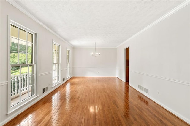 4135 Shoshone Valley Rd, Marietta, GA 30068 - empty room featuring a chandelier, a textured ceiling, hardwood / wood-style flooring, and crown molding