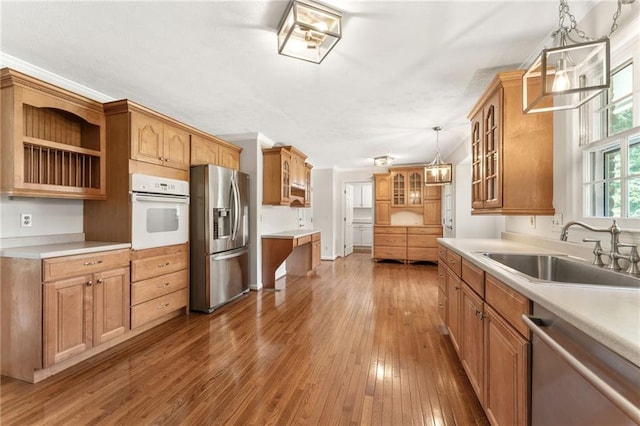 4135 Shoshone Valley Rd, Marietta, GA 30068 - kitchen with appliances with stainless steel finishes, glass insert cabinets, wood-type flooring, pendant lighting, and light countertops