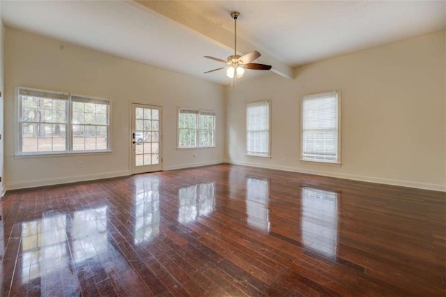 spare room featuring ceiling fan, dark wood-type flooring, and beamed ceiling