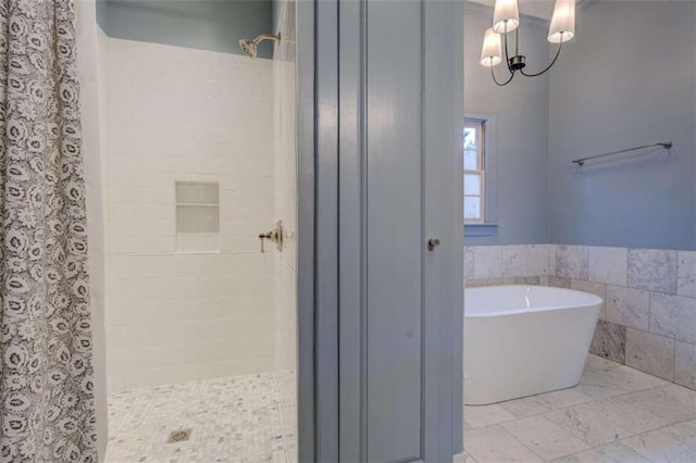 bathroom featuring separate shower and tub and tile walls