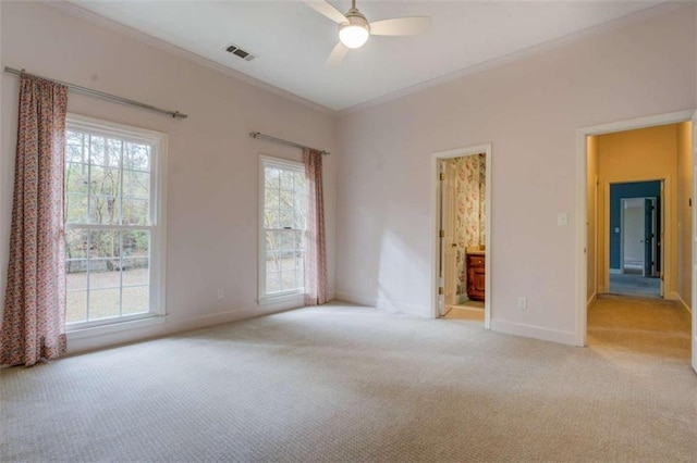 unfurnished room featuring light carpet, ornamental molding, and ceiling fan