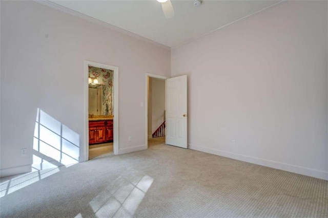 unfurnished room with light colored carpet and ceiling fan