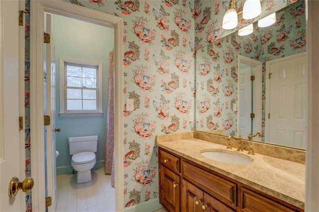 bathroom with vanity, tile patterned floors, and toilet