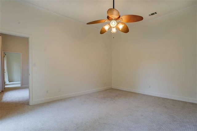 carpeted spare room with ceiling fan