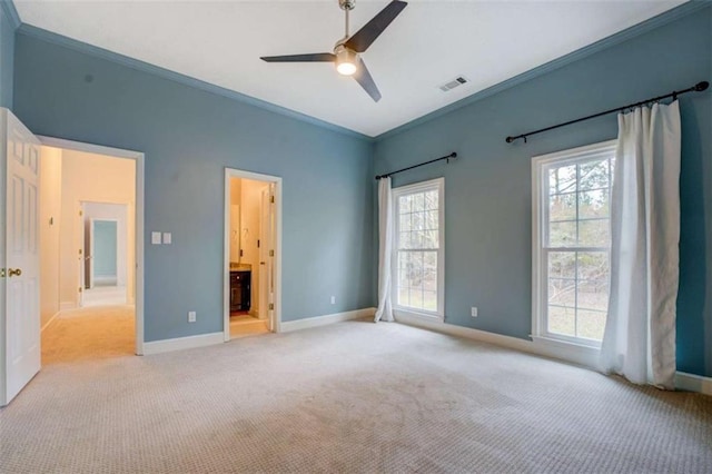 unfurnished bedroom featuring crown molding, light carpet, ceiling fan, and ensuite bath