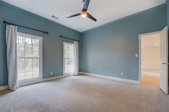 carpeted empty room with crown molding and ceiling fan