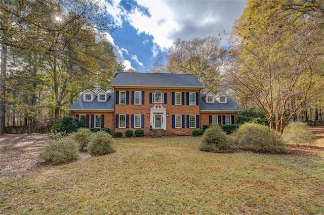 colonial inspired home with a front lawn